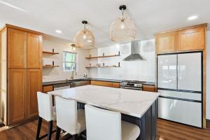 a kitchen with a kitchen island with white counter tops at Lake Granbury House, Sleeps 11 with Lake Access! in Granbury