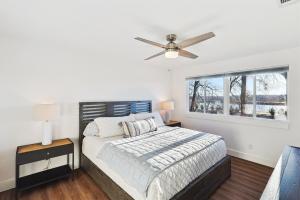 a bedroom with a bed with a ceiling fan at Lake Granbury House, Sleeps 11 with Lake Access! in Granbury