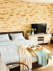 a bedroom with a bed and a tv on a table at Agro nad jeziorem in Miastko