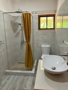a bathroom with a shower and a sink and a toilet at Villa Maria Anse Corail in Takamaka +35 photos