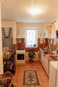 a kitchen with a sink and a table and a window at Berlin Home by RentALL in Gheorgheni