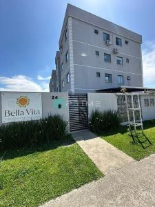 a building with a sign in front of it at Studio 406 Paranagua in Paranaguá