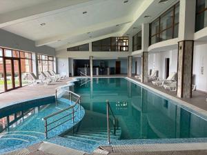 a large swimming pool in a large building at Panorama View in Bansko