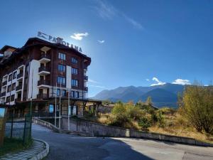 a building on the side of a road with mountains at Panorama View in Bansko