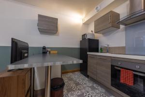 a kitchen with a counter top and a refrigerator at Studio plein centre in Aix-les-Bains