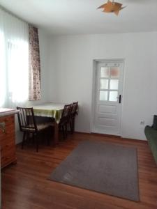 a living room with a table and chairs and a door at Grădina Zoriza in Buzău +22 photos