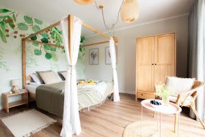 a bedroom with a canopy bed and a table at Ostoya Skalanka KDN in Zwardoń