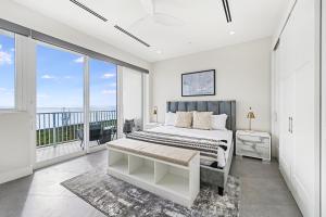 a bedroom with a bed and a large window at Point West Premier Rentals in West Bay +136 photos