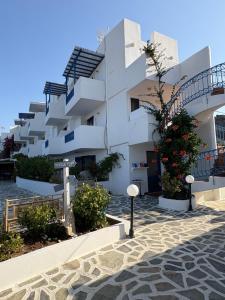 a white building with stairs on the side of it at Bay Watch in Karpathos
