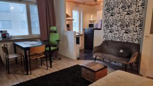 a living room with a table and a dining room at Cozy Studio in Kouvola