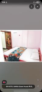 a small bedroom with a bed with a floral blanket at Sri Hotel Ganga Couple&Family Friendly in Patna
