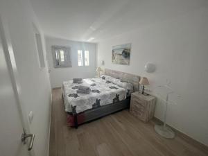 a bedroom with a bed in a white room at Can Fede in Cala Tarida