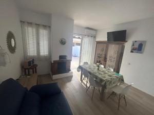 a living room with a table and chairs in a room at Can Fede in Cala Tarida