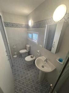 a bathroom with a sink and a toilet and a mirror at Can Fede in Cala Tarida +11 photos