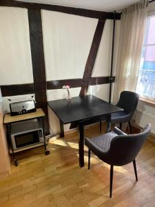a dining room with a black table and chairs at Ad Monte in Cochem