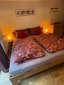 a bed with two red pillows on top of it at Ad Monte in Cochem