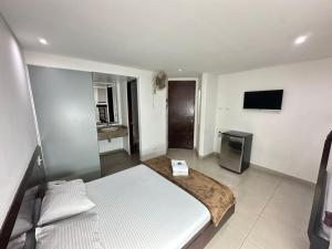 a bedroom with a bed and a television in it at Hotel Via 45 Centro in Medellín