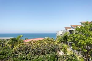 a building with the ocean in the background at Luxury Ocean View Escape with Private Rooftop -Sancta Maria in Kingsborough