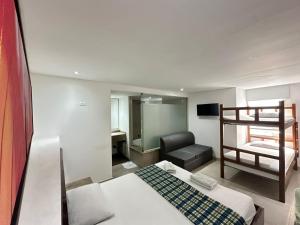 a bedroom with a bed and a bunk bed at Hotel Via 45 Centro in Medellín