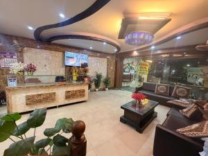 a lobby with a couch and a table in a room at Ashirwad Lucknow in Lucknow
