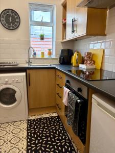 a kitchen with a washing machine and a sink at Blackpool Rocks Pleasure Beach in Blackpool