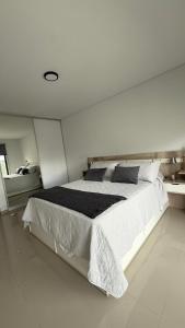 a large white bedroom with a large bed in it at Portal Patagónico in Puerto Madryn