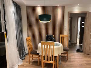 a dining room with a table and chairs at Apartament Emilia in Koszalin +6 photos