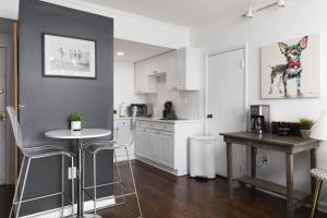 a kitchen with a table and a dog picture on the wall at Home to the Stars on Music Row with Pool and Free Parking in Nashville