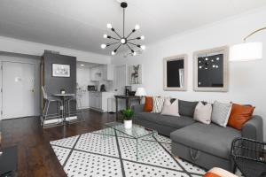a living room with a couch and a table at Home to the Stars on Music Row with Pool and Free Parking in Nashville +40 photos