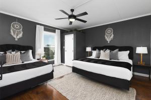 a bedroom with two beds and a ceiling fan at Home to the Stars on Music Row with Pool and Free Parking in Nashville