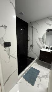 a bathroom with a shower and a sink and a mirror at Portal Patagónico in Puerto Madryn +13 photos