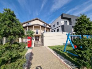a house with a red phone booth in front of it at du Mio in Eforie Nord