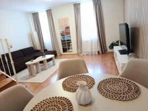 a living room with a white table and chairs at Central apartment in Staré Mesto
