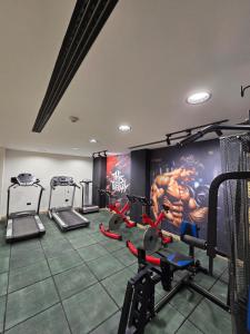 a gym with several tread machines in a room at Sand Rose Hotel Apartments in Al Khobar