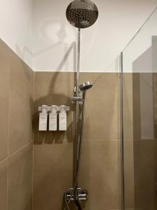 a shower in a bathroom with a glass door at Rota Beach Loft in Rota +18 photos