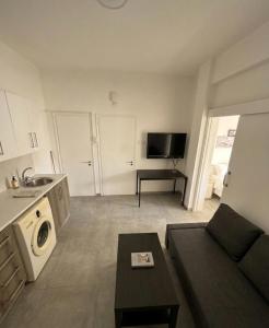 a living room with a couch and a microwave at Lux Apartment City View in Larnaca