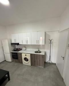 a kitchen with a sink and a washing machine at Lux Apartment City View in Larnaca