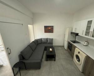 a small living room with a couch and a table at Lux Apartment City View in Larnaca