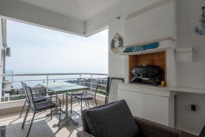 a balcony with a table and chairs and a fireplace at SeaView Lovran in Lovran