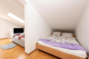 a bedroom with a bed in a attic at SeaView Lovran in Lovran