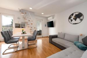 a living room with a couch and a table at SeaView Lovran in Lovran