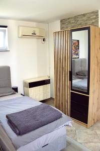a bedroom with a bed and a mirror at MM Studio in Donji Miholjac