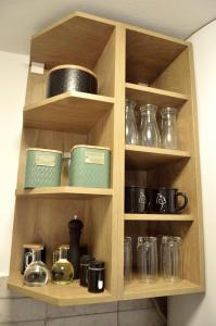 a wooden cabinet with various glass items on it at MM Studio in Donji Miholjac