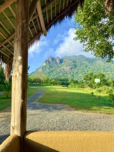 a view from the porch of a resort with a mountain at Redstone Cottage Gal Oya in Galgamuwa +53 photos