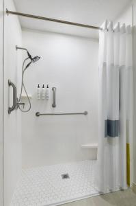 a bathroom with a shower with a shower curtain at City Express by Marriott Bemidji in Bemidji