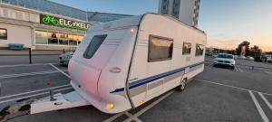 a white trailer is parked in a parking lot at Nordic Dream Camper 1 in Syfteland