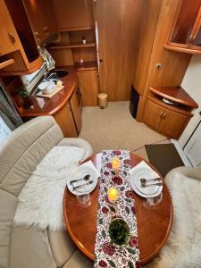 a table with two plates and two glasses on it at Nordic Dream Camper 1 in Syfteland