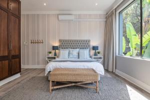 a bedroom with a bed and a large window at 11 Bonabali in Ballito
