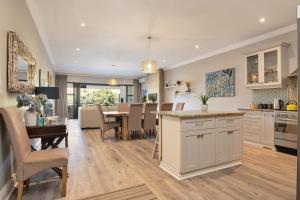 a kitchen and dining room with a table and chairs at 11 Bonabali in Ballito