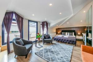 a hotel room with a bed and two chairs at Etiz Hotels & Residences in Istanbul +132 photos